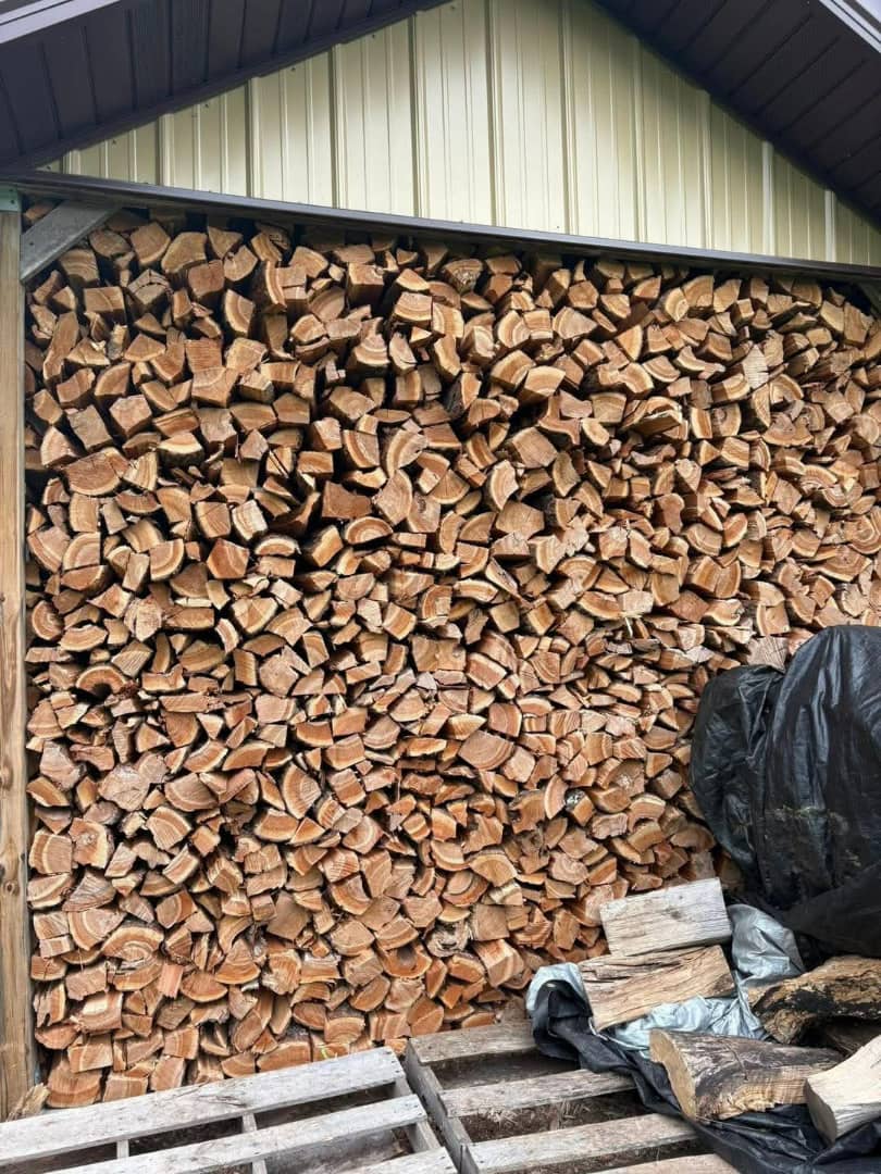 Stacked premium seasoned hardwood firewood ready for delivery